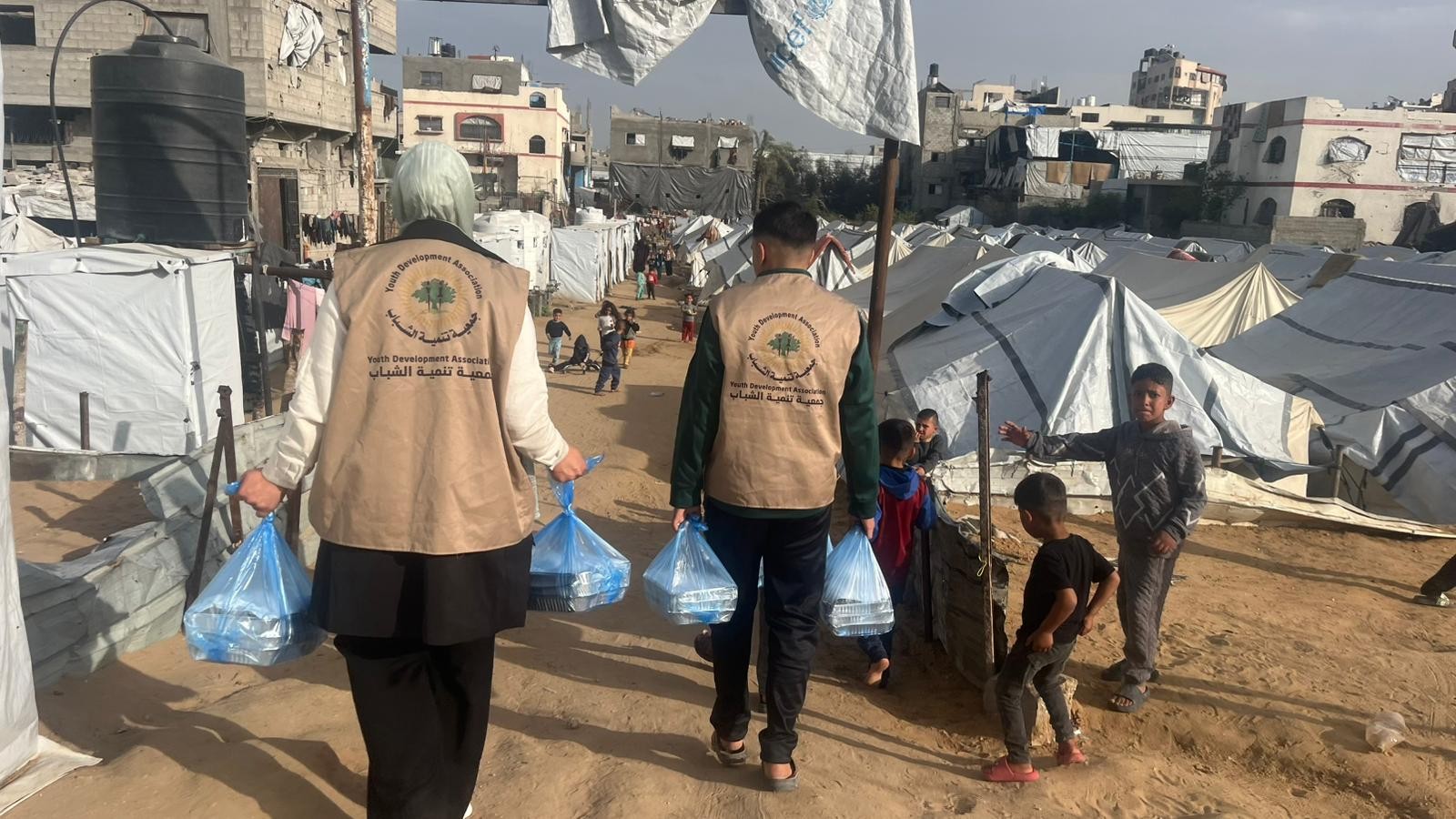 Volunteers moving through camp at Al-Nuseirat