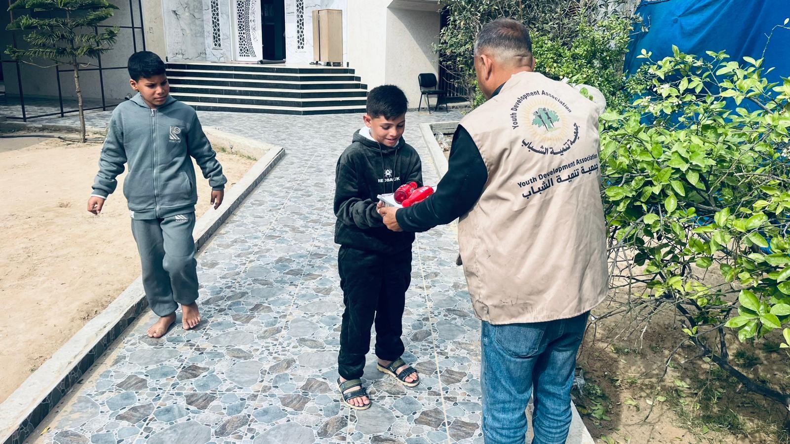 Wide view of children receiving hot meals at the Humaniti orphan shelter